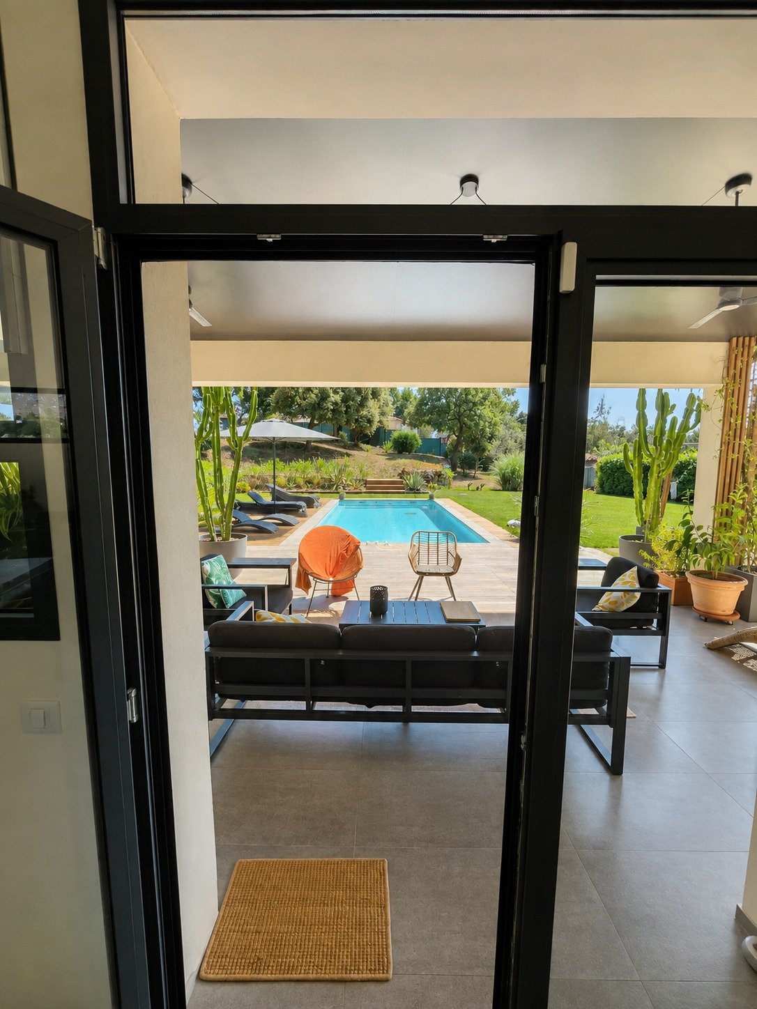 Covered terrace and pool, photographed with a phone